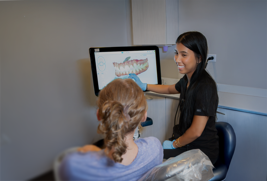 Dentist showing patient a 3D teeth scan